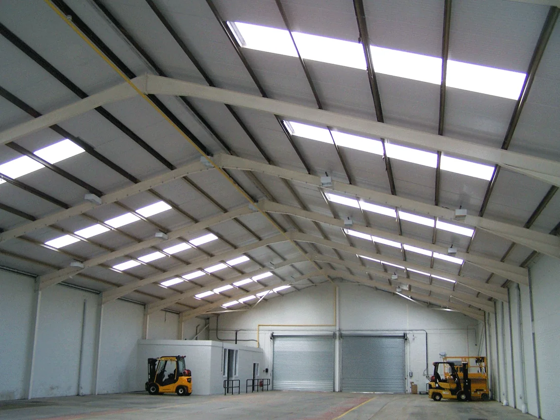 Interior of a re-clad factory unit showing new composite roof panels and rooflights, Anniesland