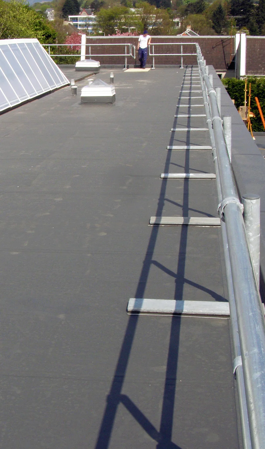 New flat roof system with edge protection handrail and rooflights at Dunoon police station