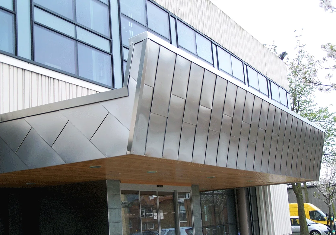 Brushed stainless steel shingle rainscreen on the entrance canopy of Motherwell Civic Hall